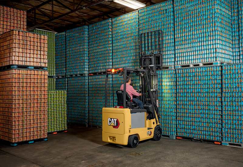 Electric Forklift Lifting Pallets of Cans