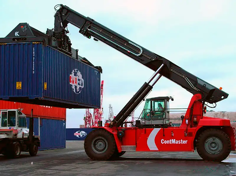 Kalmar reach stacker lifting container at shipping port